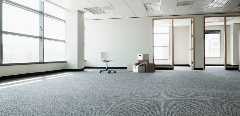 Image of an office space with nothing but a chair and boxes